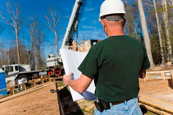 Construction worker looking at plans