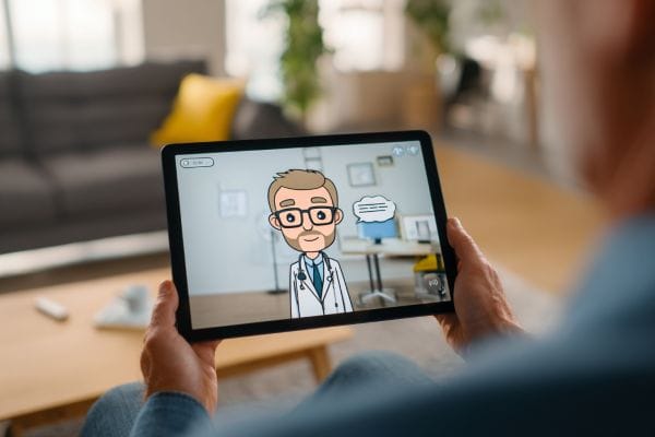 a person holding a tablet with a cartoon version of a doctor talking on the screen