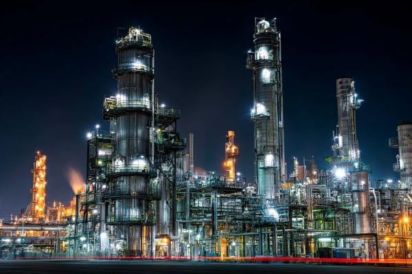 A low-emissions chemical plant lit up at night